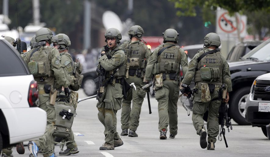 An FBI SWAT team arrives at the scene of a fatal shooting at the University of California, Los Angeles, Wednesday, June 1, 2016, in Los Angeles. (AP Photo/Nick Ut)