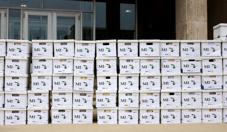 Boxes delivered full of around 350,000 petition signatures by the board of directors for MILegalize are stacked in Lansing, Mich., Wednesday, June 1, 2016. (Samantha Madar/Jackson Citizen Patriot via AP)
