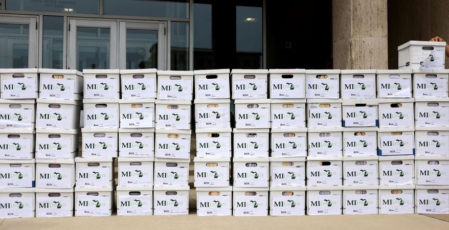 Boxes delivered full of around 350,000 petition signatures by the board of directors for MILegalize are stacked in Lansing, Mich., Wednesday, June 1, 2016. (Samantha Madar/Jackson Citizen Patriot via AP)