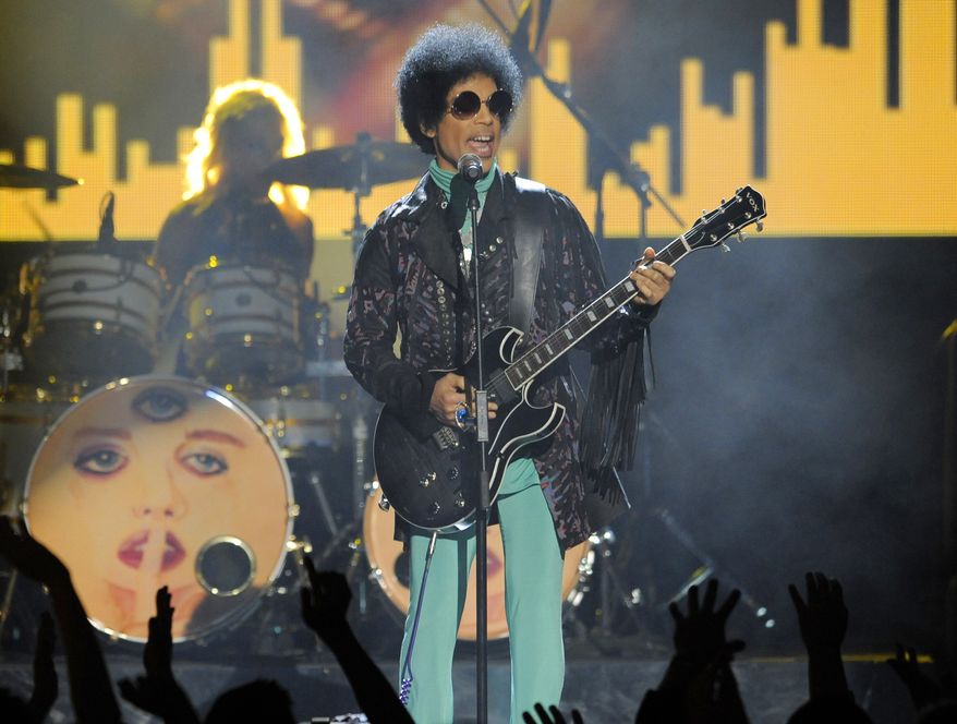 In this May 19, 2013, file photo, Prince performs at the Billboard Music Awards at the MGM Grand Garden Arena in Las Vegas. A law-enforcement official says that tests show the music superstar died of an opioid overdose. Prince was found dead at his home on April 21, 2016, in suburban Minneapolis. He was 57.  (Photo by Chris Pizzello/Invision/AP, File)