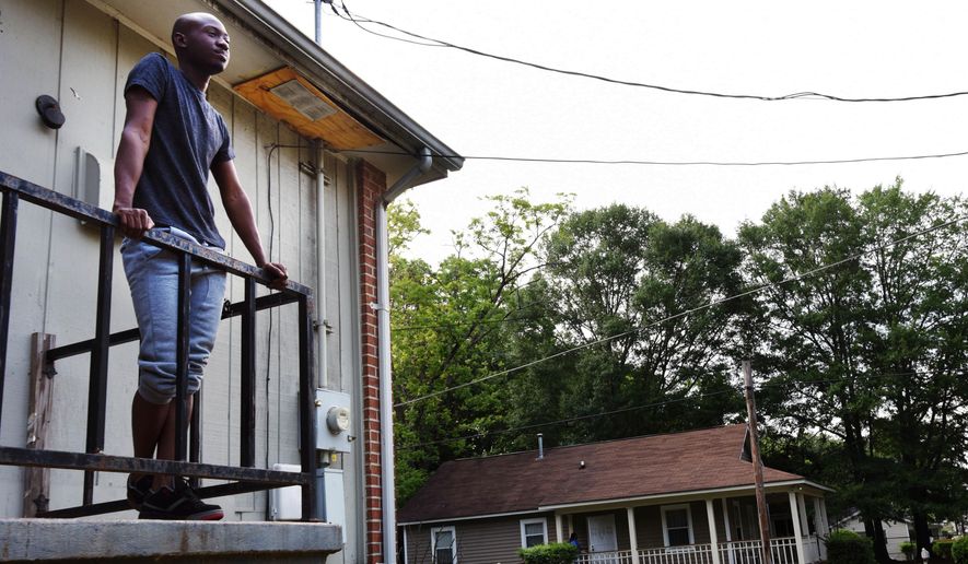 ADVANCE FOR USE SUNDAY, JUNE 5, 2016 AND THEREAFTER -In this Thursday, May 26, 2016 photo, Brandon White stands on the balcony of his former home in the Atlanta neighborhood where in February 2012, a group of young men yelling gay slurs attacked him in Atlanta. "For them to say there were no hate crimes in February, we know that isn't true," says White, 24. "That there makes it harder to trust the police." (AP Photo/Christina Almeida Cassidy)