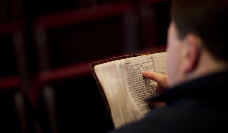 In this Sunday April 10, 2016, file photo, a parishioner reads the bible before a service at the Christian Fellowship Church in Benton, Ky. (AP Photo/David Goldman) ** FILE **