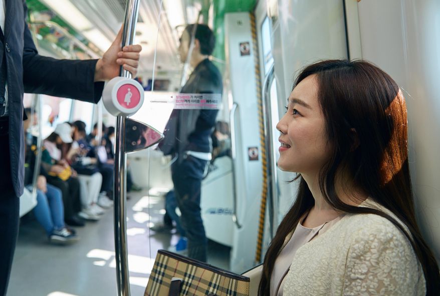 In this Wednesday, April 6, 2016 photo provided by Busan Metropolitan City, a woman sits on special priority seats next to a metal bar attached with a &amp;quot;pink light&amp;quot; wireless sensor in a subway train in Busan, South Korea. South Korea&#39;s second-largest city of Busan is testing a wireless technology it hopes can alleviate such problems and perhaps help address one of the biggest challenges facing the Asian country: a stubbornly low birthrate. (Kwon Sung-hoon/Busan Metropolitan City via AP)