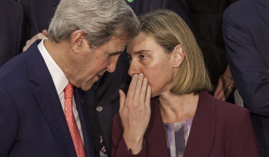 European Union High Representative for Foreign Affairs, Federica Mogherini (right) chats with U.S. Secretary of State John Kerry while posing for a group photo at the opening of an international meeting in a bid to revive the Israeli-Palestinian peace process in Paris on June 3, 2016. U.S., European and Arab diplomats meet in Paris for a French-led effort to revive the Mideast peace process, despite skepticism from Israel. (Associated Press)