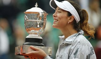 Spain&#39;s Garbine Muguruza holds the trophy after winning the final of the French Open tennis tournament against Serena Williams of the U.S. in two sets 7-5, 6-4, at the Roland Garros stadium in Paris, France, Saturday, June 4, 2016. (AP Photo/Alastair Grant)