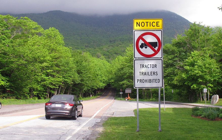 A sign warns truckers not to enter the Smugglers Notch portion of Vermont Route 108, known for its tight turns as it rises through a mountain pass, in Stowe, Vt., Friday June 3, 2016. (AP Photo/Wilson Ring) ** FILE **