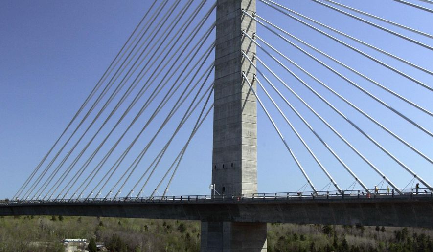 FILE- In this May 2007 file photo, the Penobscot Narrows Bridge dwarfs a sailboat passing underneath, in Prospect, Maine. The elevator serving the world's tallest bridge observatory has inconvenienced passengers on separate occasions by stranding them and forcing them to trudge down flights of stairs in the nine years since it opened, according to state documents. (AP Photo/Robert F. Bukaty, File)