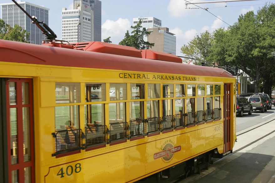 File - In this Oct. 5, 2005, file photo a streetcar travels on tracks in downtown Little Rock, Ark. As Oklahoma City prepares to break ground on its first streetcar line in seven decades, and as other cities adjust to having them again, authors of a federally backed study suggest their routes move people with a purpose, not just target the tourist trade. (AP Photo/Danny Johnston, File)