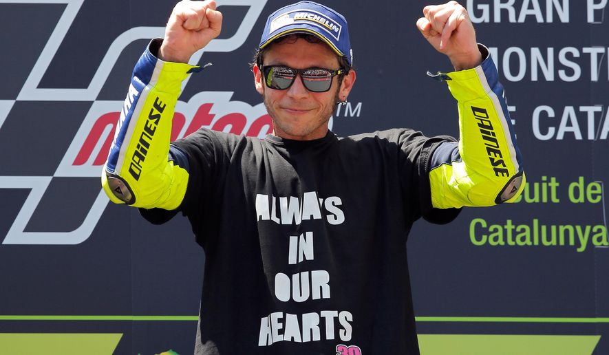 Moto GP rider Valentino Rossi of Italy celebrates on the podium after winning the Catalunya Motorcycle Grand Prix at the Barcelona Catalunya racetrack in Montmelo, just outside Barcelona, Spain, Sunday, June 5, 2016. (AP Photo/Manu Fernandez)