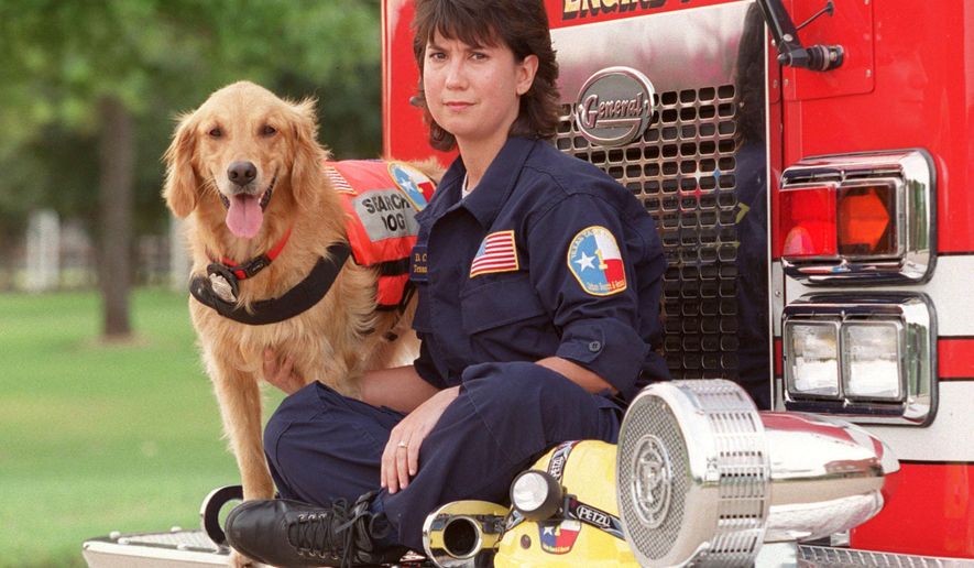This Sept. 11, 2002, photo shows, K9 Search Specialist Denise Corliss and her search dog Bretagne in Houston, Texas. Bretagne the last known living 9/11 search dog has died in a Houston suburb at age 16. Bretagne was 2 years old when she and her handler, Corliss, were part of the Texas Task Force 1 sent to the World Trade Center site in Lower Manhattan after the terrorist attack brought down the buildings on Sept. 11, 2001. (D Fahleson/Houston Chronicle via AP) MANDATORY CREDIT