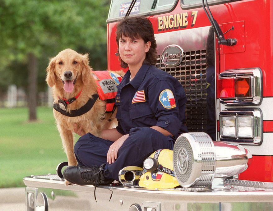 This Sept. 11, 2002, photo shows, K9 Search Specialist Denise Corliss and her search dog Bretagne in Houston, Texas. Bretagne the last known living 9/11 search dog has died in a Houston suburb at age 16. (D Fahleson/Houston Chronicle via AP)