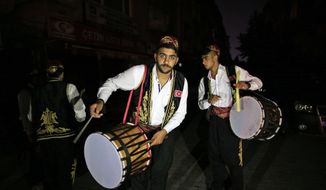 On the first day of the Muslim holy month of Ramadan, drummers, wearing traditional Ottoman clothes, perform through the neighborhoods of Istanbul, early Monday June 6, 2016, to wake people for the &quot;sahour,&quot; the traditional breakfast of Ramadan. More than 2000 drummers wander Istanbul&#39;s neighborhoods playing their drums in the early hours to wake up the residents as part of the holiday tradition. (AP Photo/Lefteris Pitarakis)