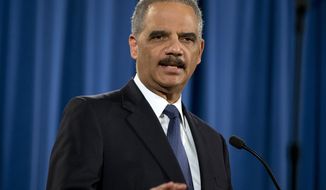 In this March 4, 2015 photo, then-Attorney General Eric Holder speaks at the Justice Department in Washington about the Justice Department’s findings related to two investigations in Ferguson, Mo. (Associated Press) **FILE**