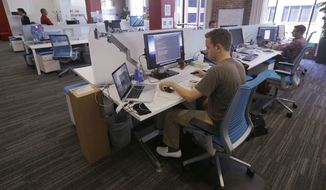 Employees work at their stations at the Target Technology Innovation Center office in San Francisco. At a 21 percent turnover rate last year, millennials were three times more likely than nonmillennials to report changing jobs, and 60 percent said they were currently open to a change in employment, more than 15 points higher than nonmillennials. (Associated Press)