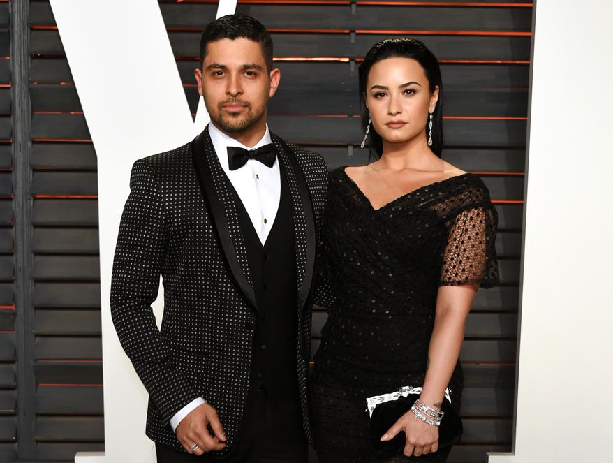 In this Feb. 28, 2016, file photo, Wilmer Valderrama, left, and Demi Lovato arrive at the Vanity Fair Oscar Party in Beverly Hills, Calif. Lovato and Valderrama have announced Friday, June 3 on their social media accounts, that they’re ending their relationship after nearly six years together. (Photo by Evan Agostini/Invision/AP, File)