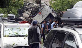 Turkish security officials and firefighters work at the explosion site after a bus carrying riot police official was struck by a bomb in Istanbul, Tuesday, June 7, 2016. At least five police officers were wounded. The blast occurred at a busy intersection near an Istanbul University building in the city&#39;s Beyazit district during the morning rush hour. (DHA via AP)