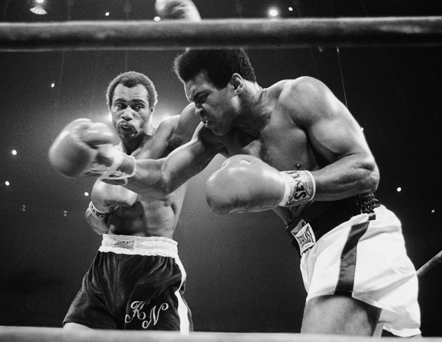 Muhammad Ali, right, winces as Ken Norton hits him with a left to the head in their scheduled 12-round re-match, Sept. 10, 1973 at the Forum in Inglewood, California. (AP Photo)
