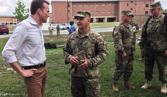 U.S. Army Secretary Eric Fanning, left, receives a briefing from Army Col. Benjamin DiMaggio about his battalions basic combat training course for new soldiers at Fort Jackson, South Carolina on Tuesday, June 7, 2016. Fanning is the new civilian leader of the Army and the first opening gay individual to lead one of the nations military services. Fanning visited Fort Jackson and is making the first stop on a number of visits he intends to make to U.S. military installations in the United States and overseas in the coming months. (AP Photo/Susanne M. Schafer)