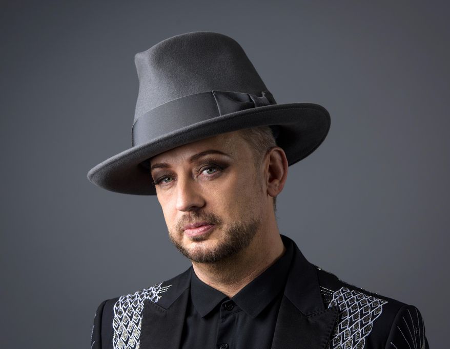 In this May 25, 2016 photo, Boy George poses for a portrait in New York. The 54-year-old entertainer just wrapped his first season as a coach on "The Voice UK" and will appear on the rebooted "Celebrity Apprentice" with Arnold Schwarzenegger later this year. (Photo by Drew Gurian/Invision/AP)