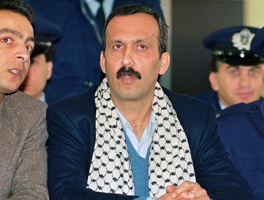 FILE - In this Dec. 12, 1991 file photo Mohammed Rashed, center, convicted of the 1982 PanAm jetliner bombing, listens to his interpreter, left, during his appeals court hearing in Athens, Greece. Rashed, the Jordanian-born Palestinian who’s been in immigration custody since he finished a prison sentence for putting a bomb on a plane in 1982 is expected to appear in a Buffalo courtroom in his bid for release. Rashed has been held at a facility outside Buffalo while the government has explored options to deport him. A federal court hearing is scheduled for Tuesday, June 7, 2016. (AP Photo/Aris Saris, File)