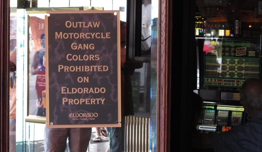 This photo taken Saturday, June 4, 2016, shows one of the signs posted at the Eldorado hotel-casino in Reno, Nev., during a Street Vibrations motorcycle festival warning that gang members cannot wear their colors. Most area casinos adopted the policy after a fatal shootout between rival gangs in Sparks in September 2011. Former Vagos leader Ernesto Gonzalez was found guilty of murder, but the Nevada Supreme Court overturned the conviction and his retrial is pending. (AP Photo/By Scott Sonner).