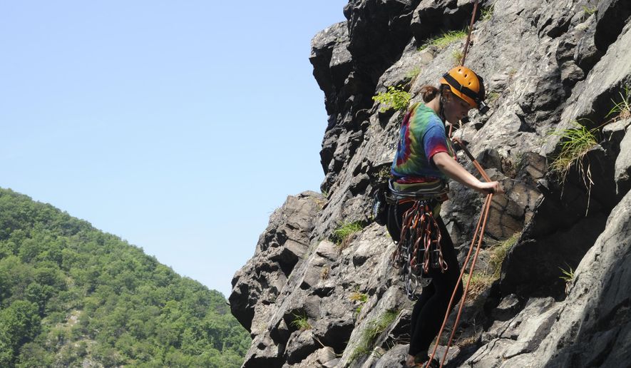 In this photo taken, Thursday, June 2, 2016, Carlie Getting, of East Stroudsburg, Pa., scales the rocky face of Mount Tammany in the Delaware Water Gap near Knowlton Township, N.J.(Kevin Kunzmann/Pocono Record via AP) MANDATORY CREDIT