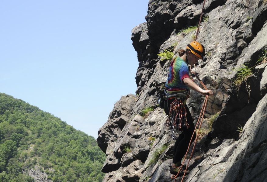 In this photo taken, Thursday, June 2, 2016, Carlie Getting, of East Stroudsburg, Pa., scales the rocky face of Mount Tammany in the Delaware Water Gap near Knowlton Township, N.J.(Kevin Kunzmann/Pocono Record via AP) MANDATORY CREDIT