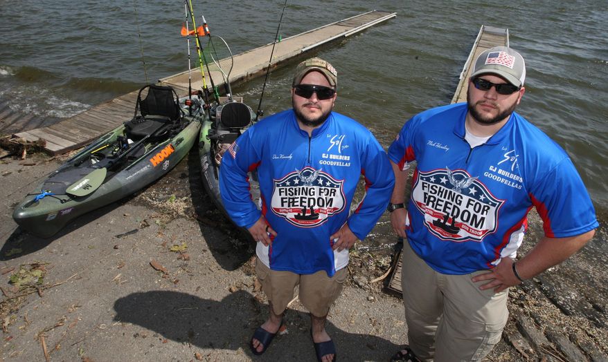 ADVANCE FOR USE SUNDAY, JUNE 12, 2016 AND THEREAFTER - In this May 24, 2016 photo, Army Veterans Dan Kennedy, left, and Nick Harding stand next to their kayaks in Decatur, Ill. The pair are veteran anglers who have become fishers of men. Harding and Kennedy belong to an organization with the jolting title "#22KILL." #22KILL draws attention to the nations veteran suicide rate and some of the underlying miseries that drive the veteran suicides, such as post-traumatic stress disorder, the malady as old as war itself that targets soldiers whose eyes have seen too much. Several organizations are using fishing to bring some cheer to veterans' lives. (Jim Bowling/Herald & Review via AP) MANDATORY CREDIT