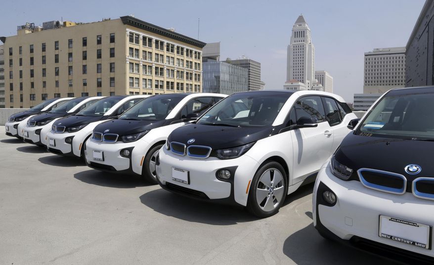Electric cars are parked atop the Los Angeles Police Department parking lot, in Los Angeles on Wednesday, June 8, 2016. The Los Angeles Police Department has added 100 electric cars to its fleet as replacements for aging vehicles. The newly leased additions to the department motor pool announced Wednesday are BMW i3 models. The cars are not for regular police patrols. They will largely be used by the department's civilian work force and sometimes by officers. (AP Photo/Nick Ut)