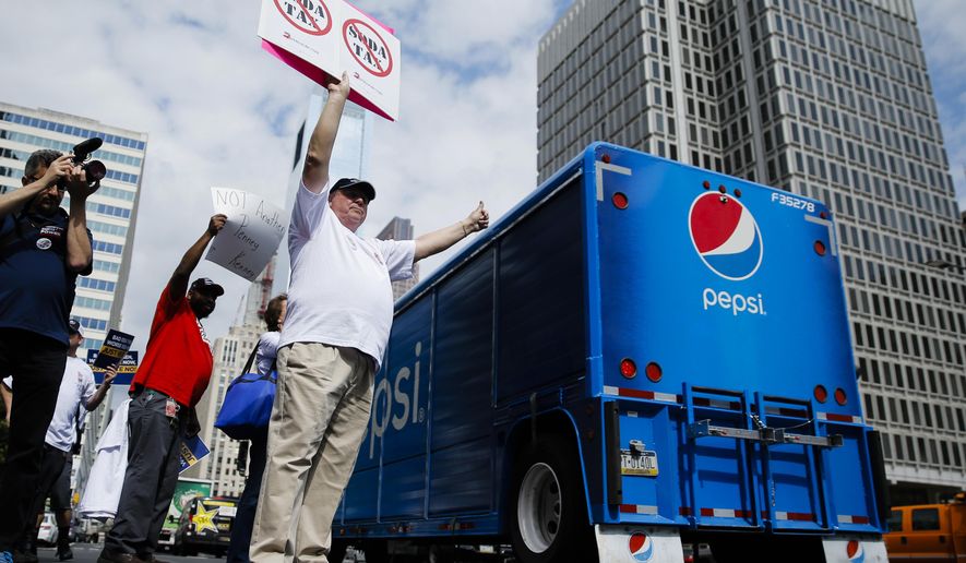Opponents of a proposed sugary drink tax demonstrate outside City Hall in Philadelphia, Wednesday, June 8, 2016. Philadelphia City Council is set to consider a sugary drink tax that Philadelphia Mayor Jim Kenney wants to pay for universal prekindergarten, community schools and park improvements. (AP Photo/Matt Rourke)