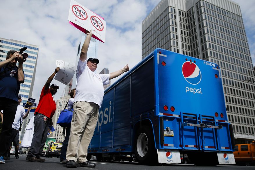 Opponents of a proposed sugary drink tax demonstrate outside City Hall in Philadelphia, Wednesday, June 8, 2016. Philadelphia City Council is set to consider a sugary drink tax that Philadelphia Mayor Jim Kenney wants to pay for universal prekindergarten, community schools and park improvements. (AP Photo/Matt Rourke)