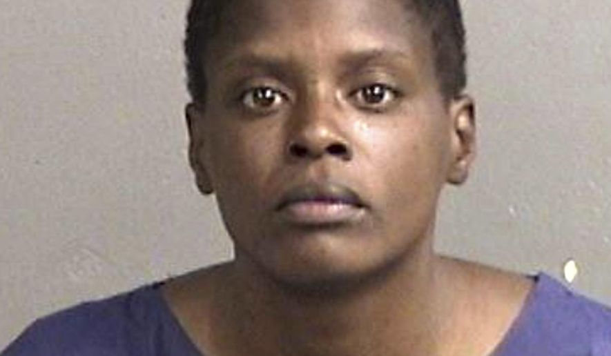 This June 2016 booking photo provided by the Alameda County Sheriff's Office shows Iyona Dzshae Hammond. Authorities say Hammond, accused of stabbing a 12-year-old boy in the back three times as she tried to rob a Northern California bank on Monday, June 6, is expected to be charged with attempted murder. The boy is in stable condition after surgery. (Alameda County Sheriff's Office via AP)