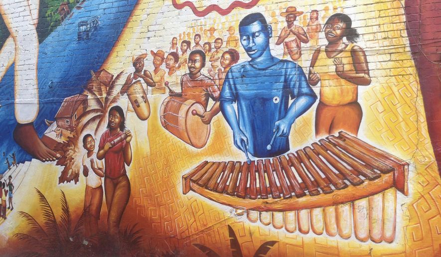 While Travis Gardner, 32, of the Brass Connection Band plays to a crowd in Georgetown, a mural on U Street serves only as a memory for some of the District's oldest jazz clubs. (Faith E. Pinho/The Washington Times)