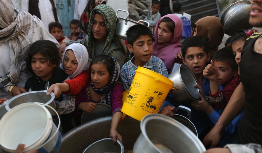 Afghan villagers receive free food donated by other villagers as they prepare to break their fast during the holy month of Ramadan in Kabul, Afghanistan, Thursday, June 9, 2016. Muslims across the world are observing the holy fasting month of Ramadan, when they refrain from eating, drinking and smoking from dawn to dusk. (AP Photo/Rahmat Gul)