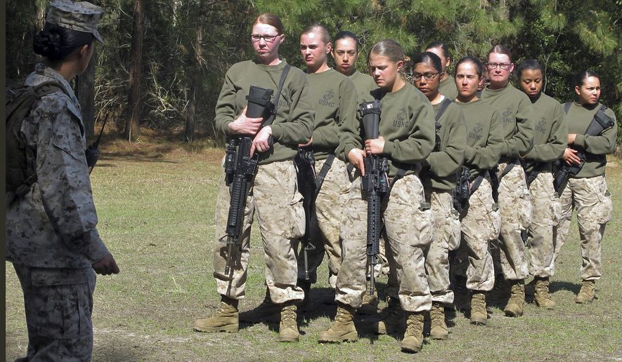 FILE - In this Feb. 21, 2013 file photo, female recruits stand at the Marine Corps Training Depot on Parris Island, S.C. U.S. Secretary of the Navy Ray Mabus said in an interview on June 3, 2016, that the Navy and Marine Corps will be dropping "man" from some of their job titles to make them inclusive and gender-neutral. (AP Photo/Bruce Smith, File)