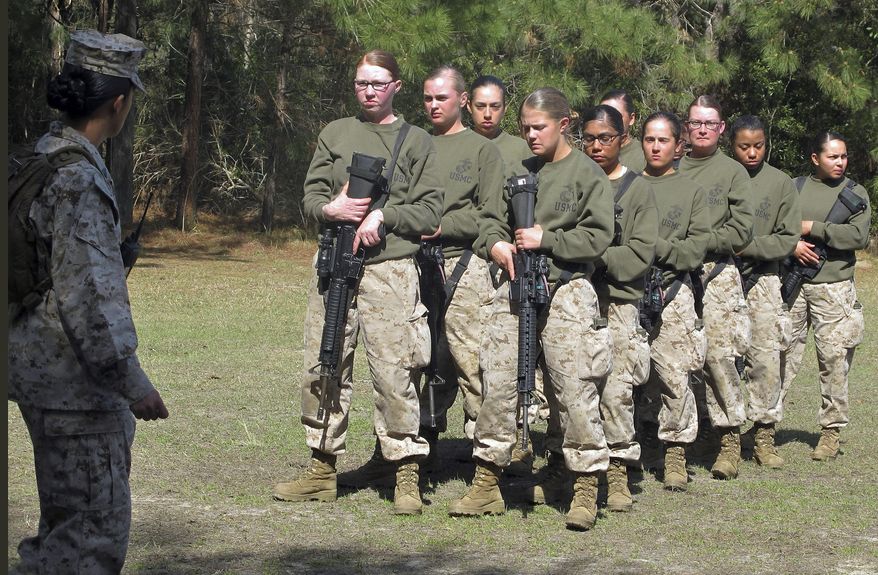 FILE - In this Feb. 21, 2013 file photo, female recruits stand at the Marine Corps Training Depot on Parris Island, S.C. U.S. Secretary of the Navy Ray Mabus said in an interview on June 3, 2016, that the Navy and Marine Corps will be dropping "man" from some of their job titles to make them inclusive and gender-neutral. (AP Photo/Bruce Smith, File)