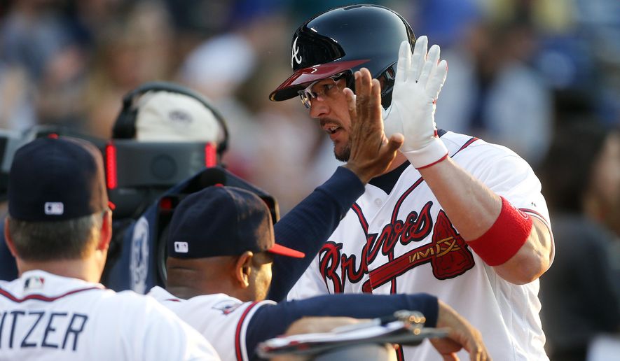 Atlanta Braves&#39; Tyler Flowers is greeted at the dugout after hitting a home run during the second inning of a baseball game against the Chicago Cubs on Friday, June 10, 2016, in Atlanta. (AP Photo/John Bazemore)