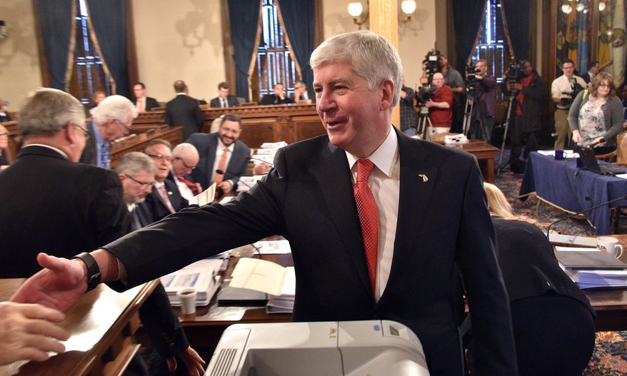 ADVANCE FOR USE SUNDAY JUNE 12, 2016 AND THEREAFTER - FILE - In this Feb. 10, 2016 file photo, Gov. Rick Snyder greets legislators in the Capitol in Lansing, Mich. Late-night drama over rescuing Detroit's school district capped lawmakers' closing days in Lansing before they broke for a summer recess. The $617 million bailout ultimately passed, barely, by just one vote in both the House and the Senate. (Dale G. Young /Detroit News via AP) DETROIT FREE PRESS OUT; HUFFINGTON POST OUT; MANDATORY CREDIT