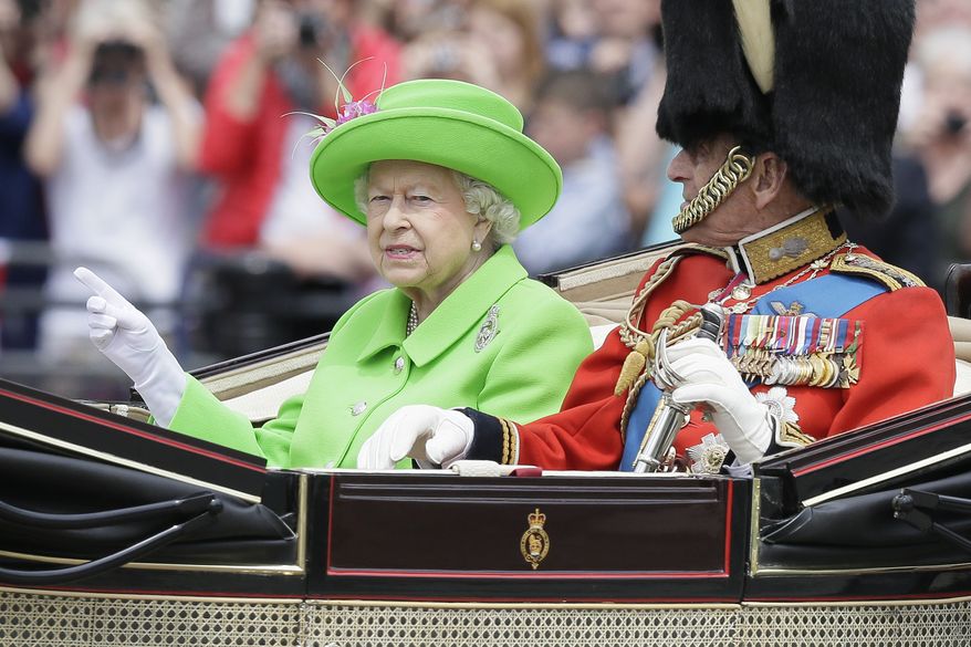 Britain's Queen Elizabeth II and Prince Philip ride in a carriage during the Trooping The Colour parade at Buckingham Palace, in London, Saturday, June 11, 2016. Hundreds of soldiers in ceremonial dress have marched in London in the annual Trooping the Colour parade to mark the official birthday of Queen Elizabeth II. The Trooping the Colour tradition originates from preparations for battle, when flags were carried or "trooped" down the rank for soldiers to see. (AP Photo/Tim Ireland) ** FILE **