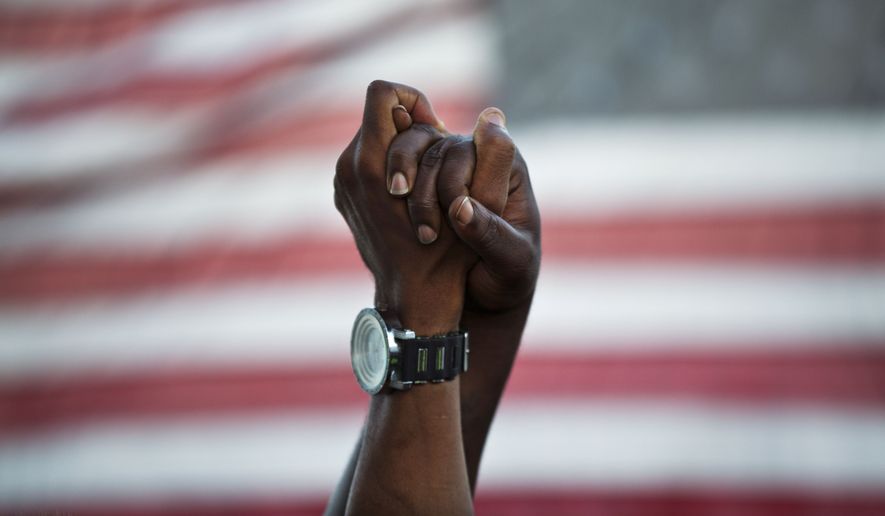 A year ago, thousands of marchers meet in Charleston, South Carolina, in a show of unity after nine black church parishioners were gunned down during a Bible study. (Associated Press/File)