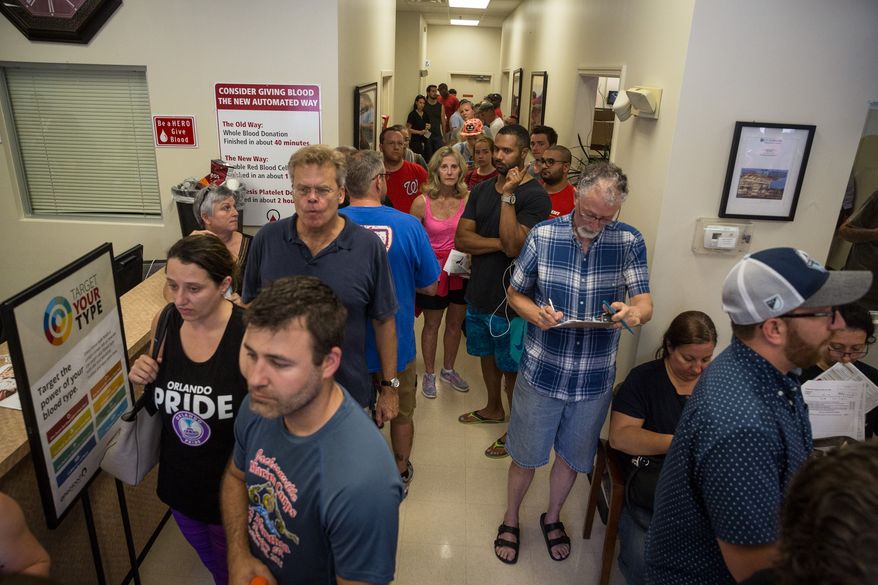 Donors line up outside OneBlood Blood Donation Center in Orlando, Fla., on Sunday, June 12, 2016. The center was flooded with donors after a mass shooting early Sunday morning at a gay nightclub, Pulse, in Orlando. (Loren Elliott/Tampa Bay Times via AP)