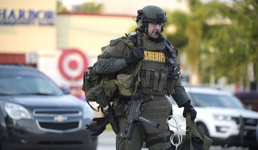 An Orange County Sheriff&#39;s Department SWAT member arrives to the scene of a fatal shooting at Pulse Orlando nightclub in Orlando, Fla., Sunday, June 12, 2016. (AP Photo/Phelan M. Ebenhack)