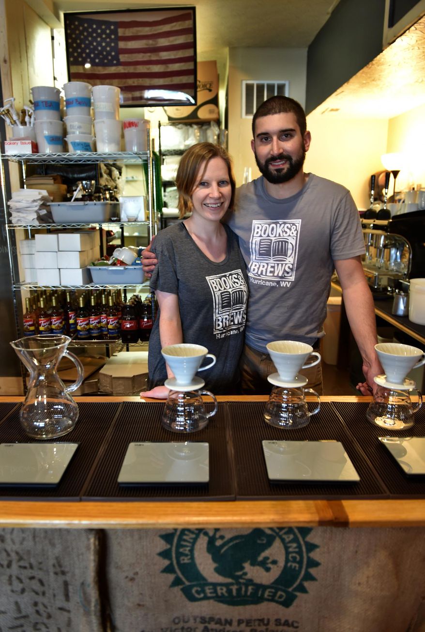 ADVANCE FOR MONDAY JUNE 13 AND THEREAFTER - In this Saturday May 25, 2016 photom Pat and Clare Pelley stand behind the counter in their restaurant, Books and Brews, in Hurricane W.Va. The couple opened Books and Brews after Pat left his job in the mining industry. The establishment recently closed to renovate the space to accommodate more customers, and also to add beer and wine to the menu. (Kenny Kemp/Charleston Gazette-Mail via AP)