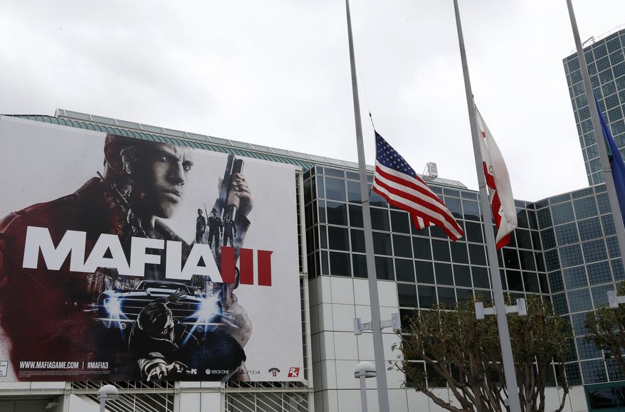 Flags outside the Electronic Entertainment Expo in Los Angeles, fly at half-staff on Monday, June 13, 2016 in honor of the victims of the gay nightclub attack in Orlando. E3 kicked off Sunday and Monday with flashy presentations featuring footage of upcoming games, many of which depict unrelenting gun violence, from Electronic Arts, Bethesda Softworks, Microsoft and Ubisoft. (AP Photo/Nick Ut)