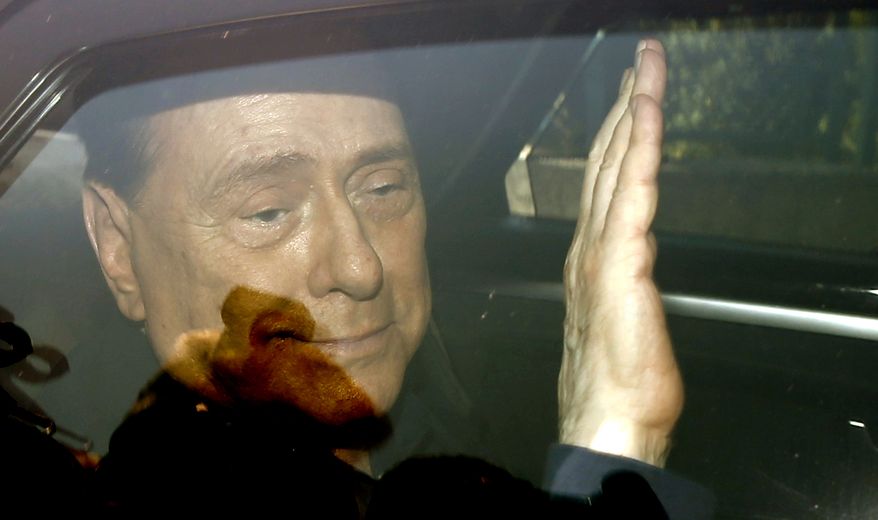 in this Friday, July 18, 2014, file photo, Italy's former Premier Silvio Berlusconi waves as he leaves the 'Sacra Famiglia' institute in Cesano Boscone, Italy. Media mogul Silvio Berlusconi, who served three times as Italian premier, was undergoing heart surgery Tuesday, June 14, 2016 at a Milan hospital. (AP Photo/Luca Bruno, File)