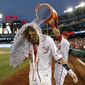 Jayson Werth gets doused by Wilson Ramos after his the game-winning RBI single. The Nationals won 5-4, in 12 innings. (AP Photo/Alex Brandon)