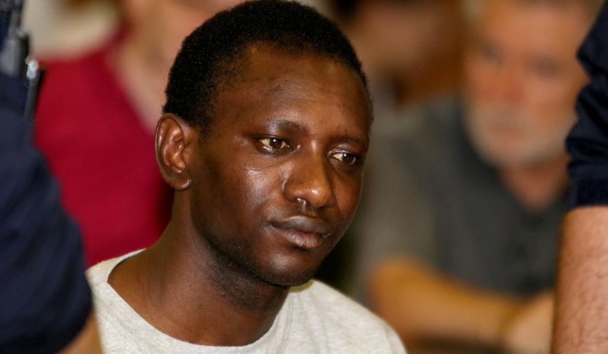 Abdou I. (no second name given) from Gambia waits for the start of his trial at the main court in Vienna, Austria, Wednesday, June 15, 2016. He is suspected to be the murderer of a 25-year old au pair girl from Colorado, United States who lived in Vienna. (AP Photo/Ronald Zak)