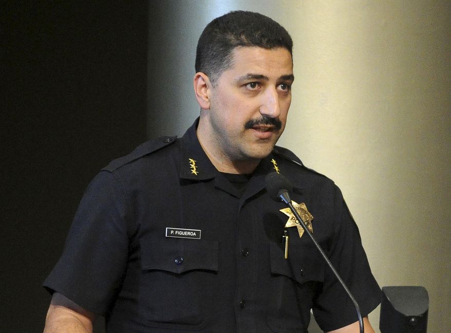This July 16, 2013 photo shows Oakland Police Assistant Chief Paul Figueroa during a city council meeting in Oakland, Calif. Oakland Mayor Libby Schaaf removed interim police chief Ben Fairow on Wednesday, June 15, 2016, after appointing him less than a week ago amid a widening sex scandal involving several officers. Figueroa will serve as acting chief. (Doug Duran/Bay Area News Group via AP) MAGS OUT NO SALES
