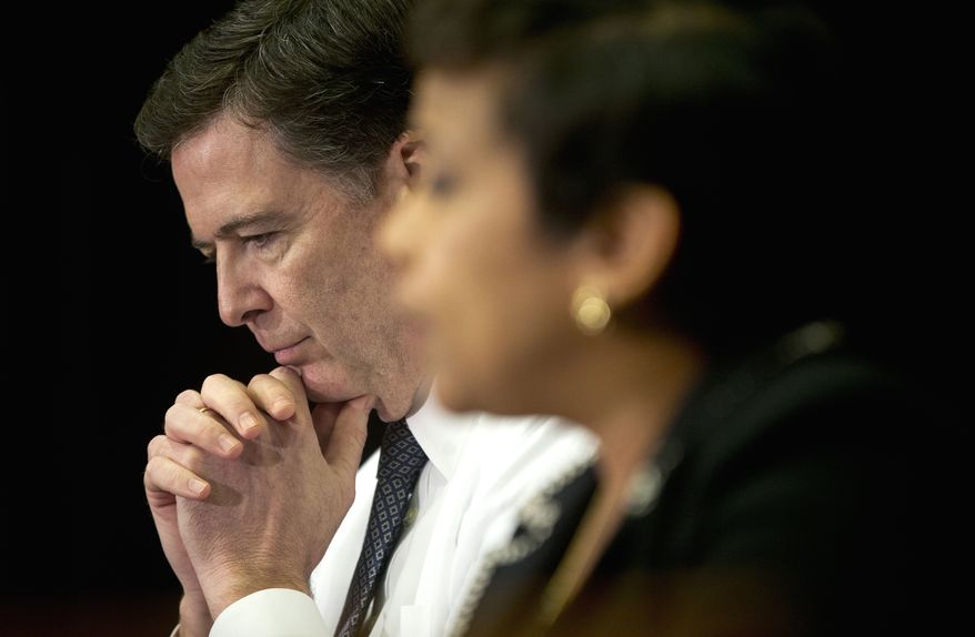 FBI Director James Comey listens at left as Attorney General Loretta Lynch speaks during their sit-down meeting with members of the media at Justice Department headquarters in Washington on Nov. 19, 2015, to discuss the U.S. government&#39;s ongoing counterterrorism efforts. (Associated Press) **FILE**