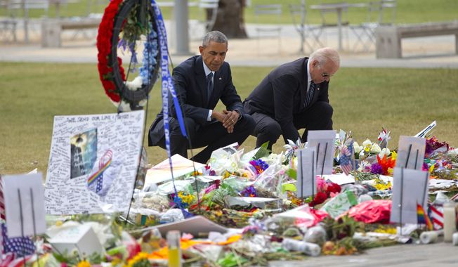 President Barack Obama and Vice President Joe Biden visit a memorial to the victims of the Pulse nightclub shooting, Thursday, June 16, 2016 in Orlando, Fla. Offering sympathy but no easy answers, Obama came to Orlando to try to console those mourning the deadliest shooting in modern U.S history. (AP Photo/Pablo Martinez Monsivais)